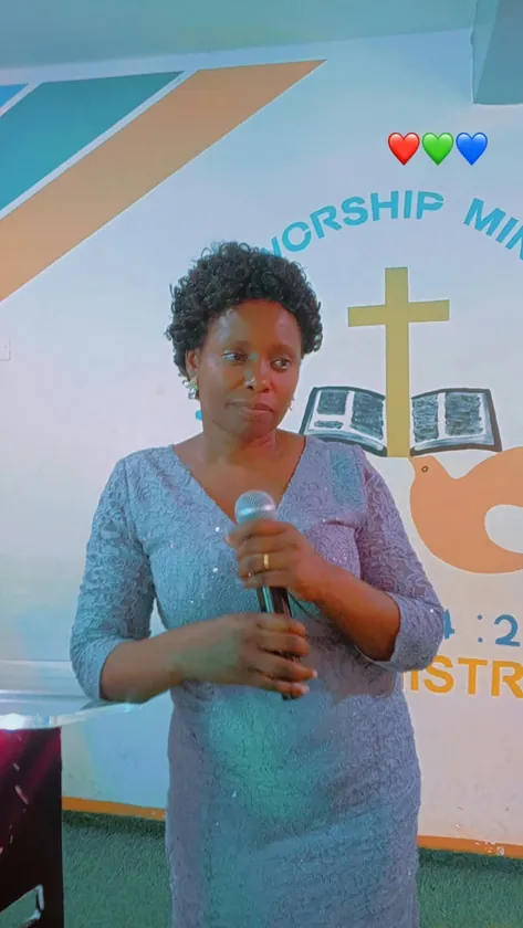 Woman holding a microphone inside True Praise church